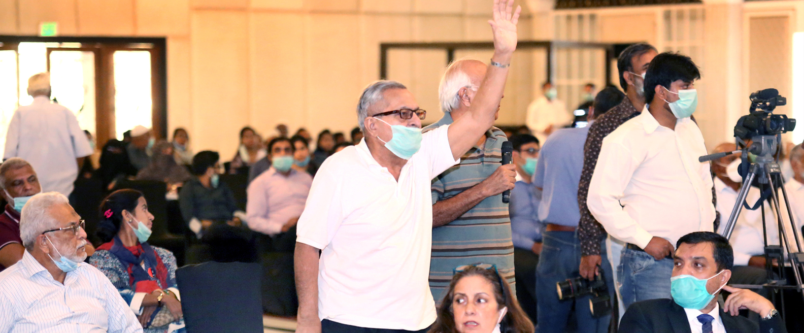 A shareholder raises hand during the question answer session at Annual General Meeting 2020 in Karachi