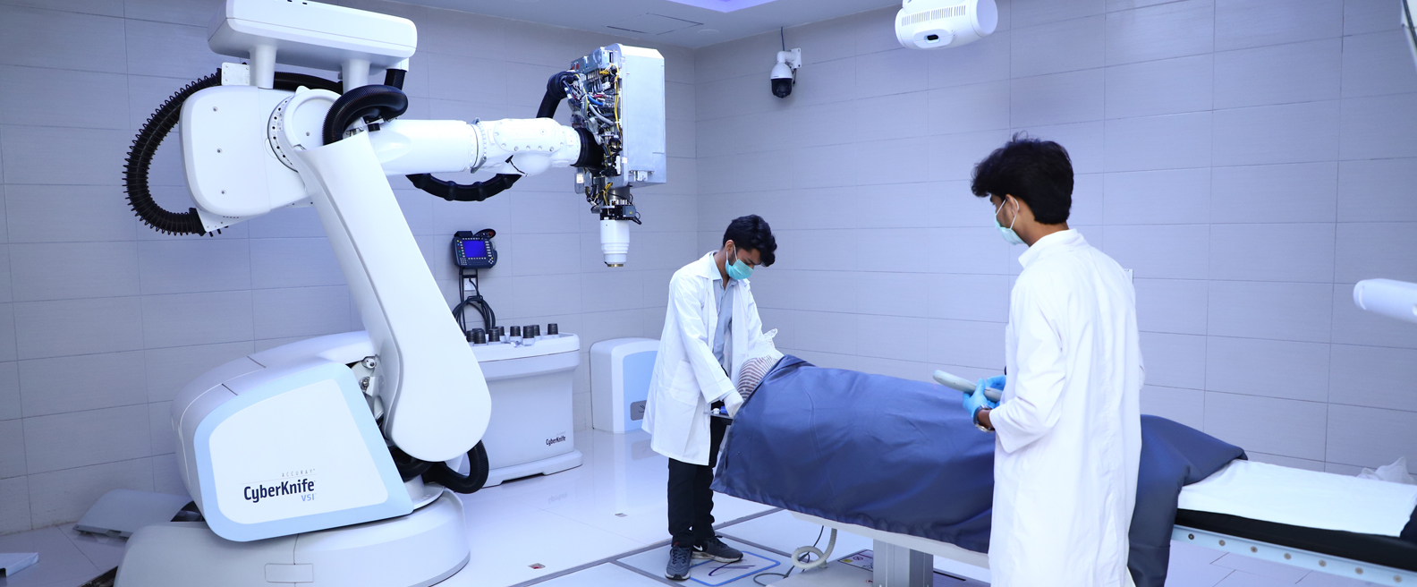 A patient being helped on CyberKnife technology equipment donated by PPL to Patients Aid Foundation for treatment of cancer patients at Jinnah Postgraduate Medical Center