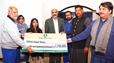 Manager Adhi Field Shaheen Parwez Akhtar (left) hands over the cheque for rehabilitation of Basic Health Units to Assistant Commissioner Gujar Khan Hira Rizwan (third left) in the presence of local government and PPL representatives. Member Punjab Assembly Chaudhry Sajid Mahmood (second right) is also present on the occasiona