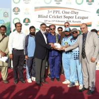 Winning Captain of team Sindh Nasir Ali is receiving 3rd PPL Blind Cricket Super League trophy from chief guest DMD PPL Khalid Raza and Chairman PBCC Syed Sultan Shah at the closing ceremony on February 15 at PAF Faisal Airbase Ground  Karachi