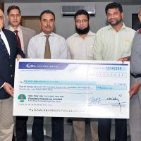 (first left) MD and CEO PPL Syed Wamiq Bokhari presenting the donation cheque for construction of Centre of Excellence for Deaf to Co-president Pakistan Association of the Deaf Irfan Mumtaz (sixth left) in the presence of officials from both organizations